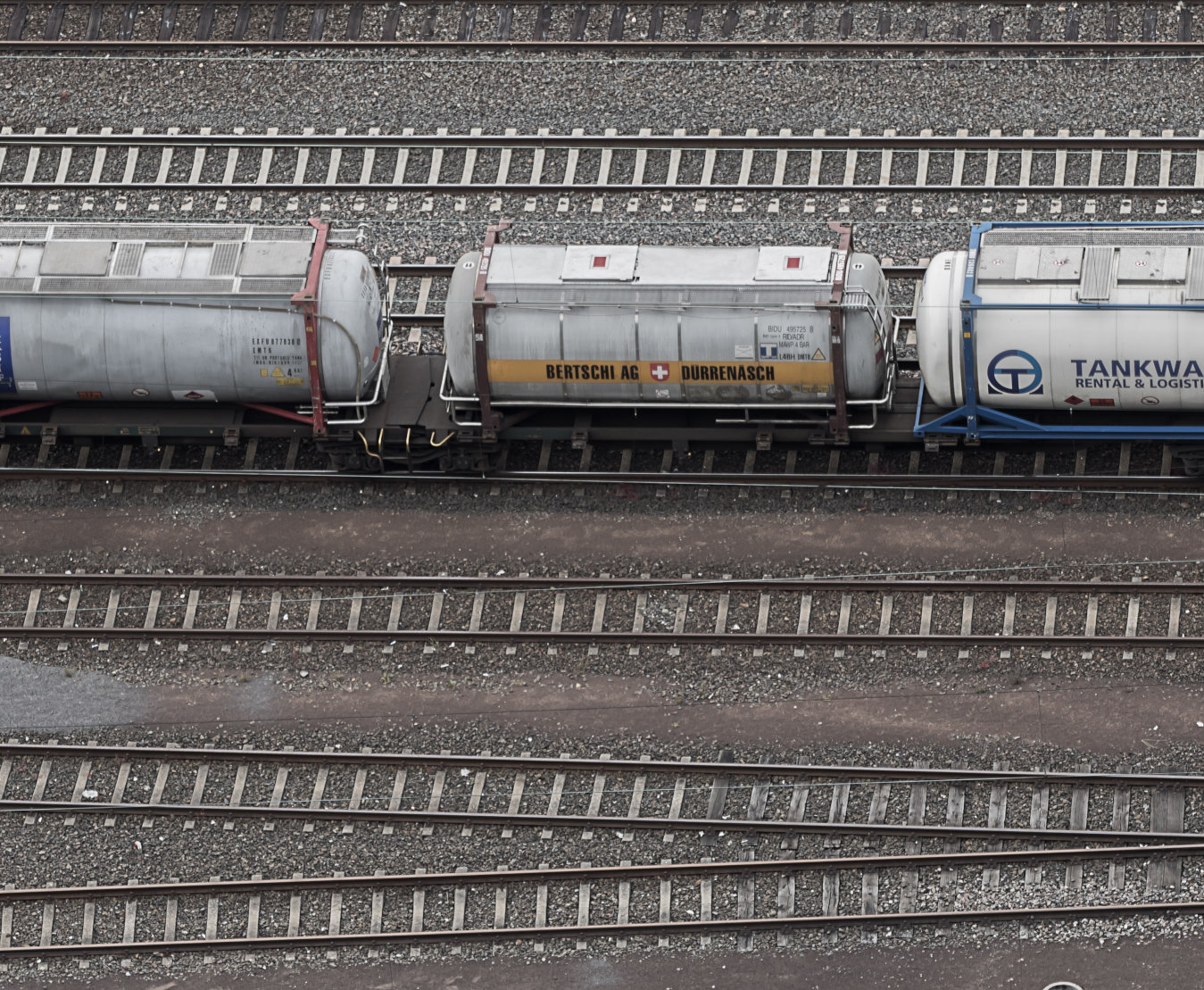 a view of a train track with buildings in the background